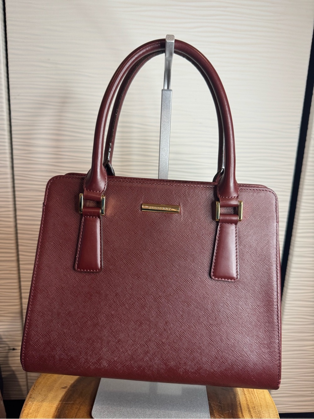 Burberry leather Burgundy Satchel with Gold Accents and double handles.